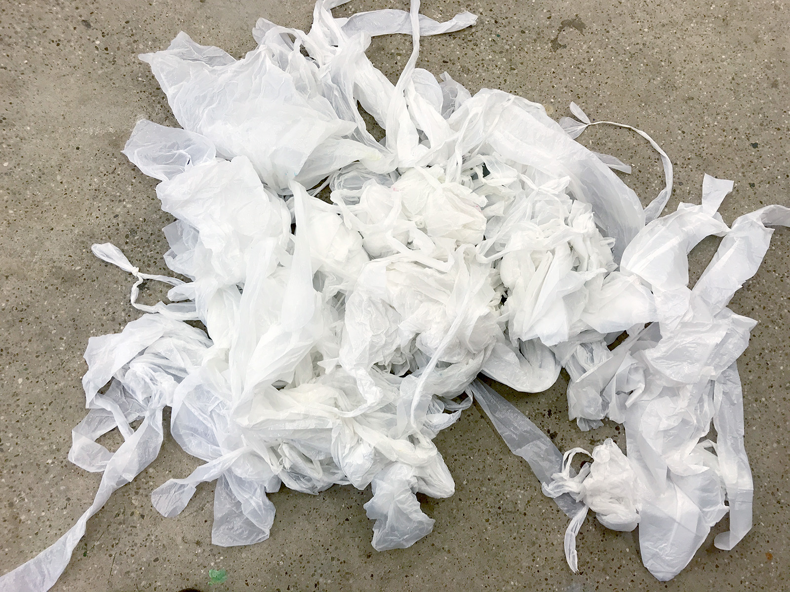 White disposable aprons as source material for the workshop.